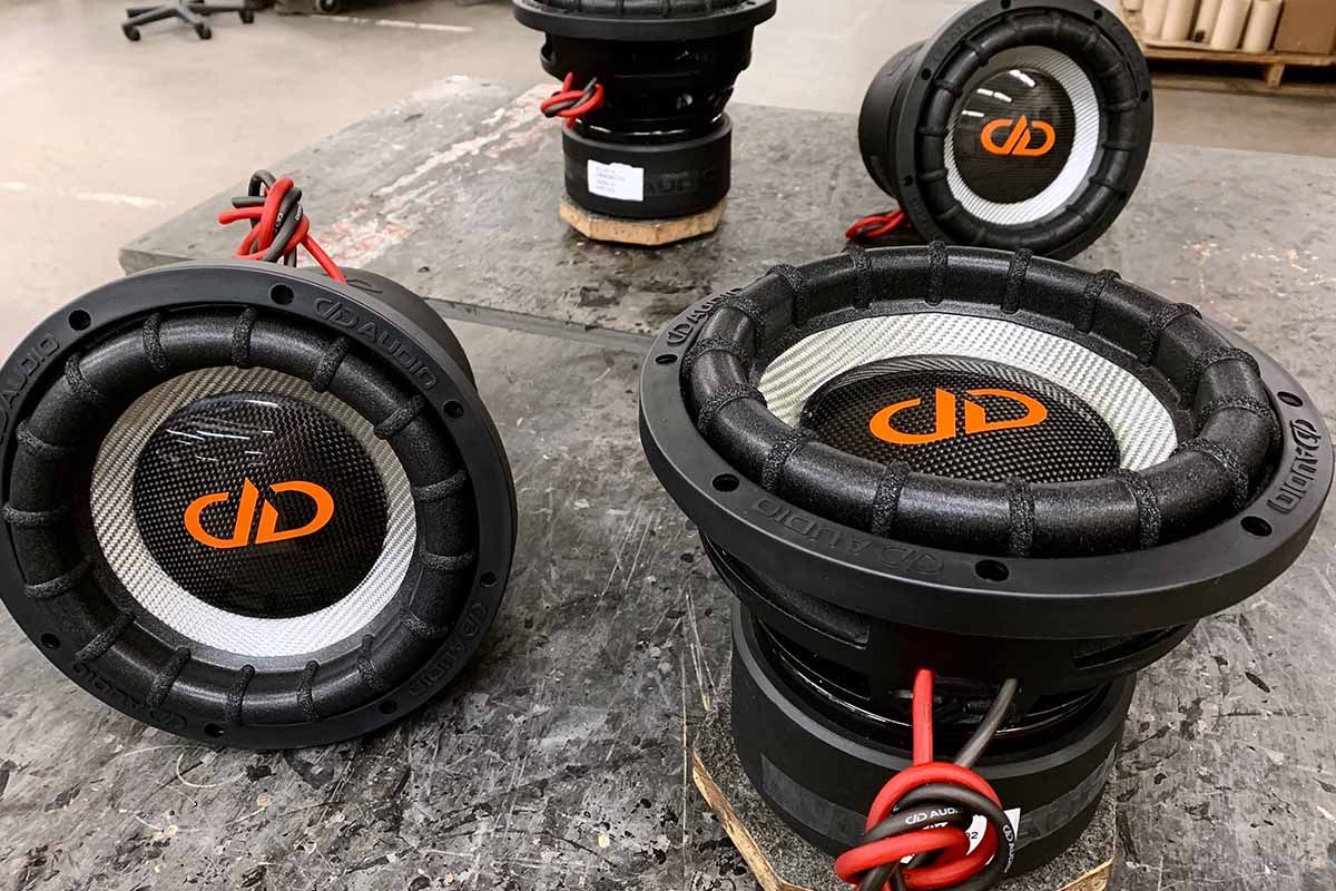 Four USA Made Subwoofers with silver carbon fiber cones, black high gloss dust caps and red DDA logos