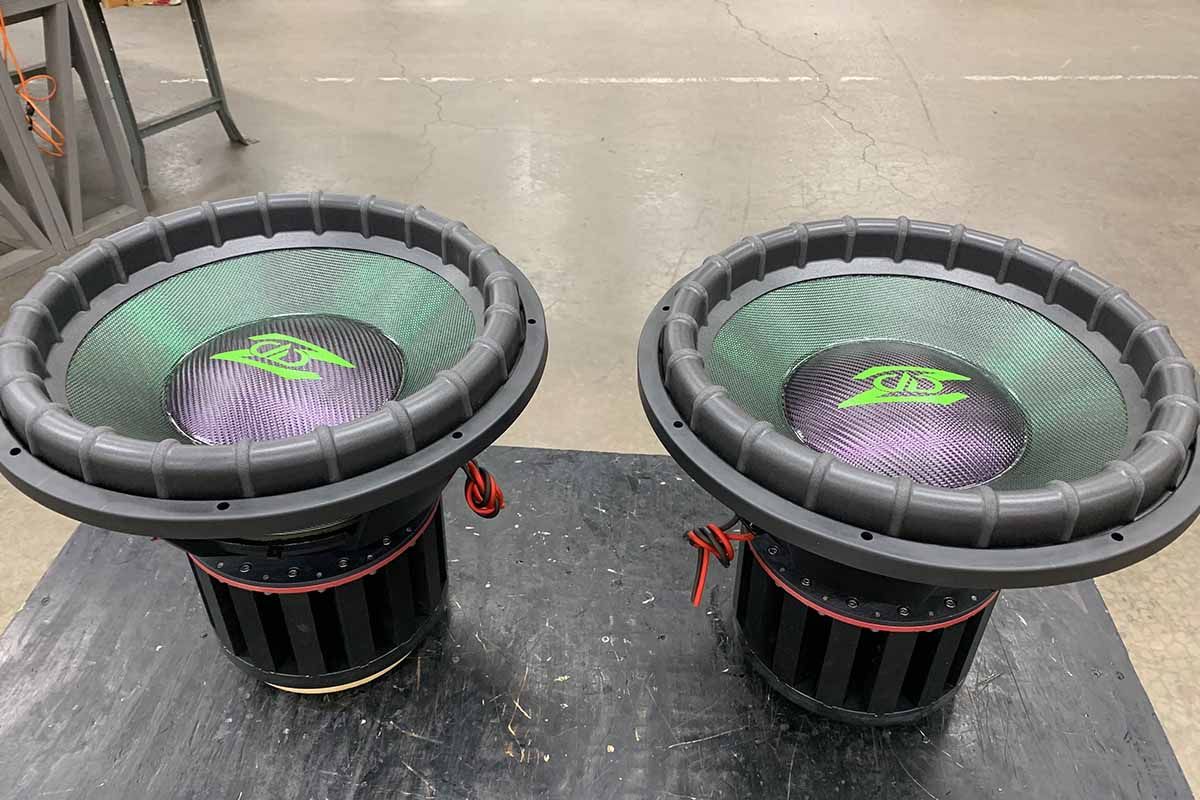 Two USA Made Subwoofers with green polychromatic cones, purple polychromatic dust caps and green DD Z Logos
