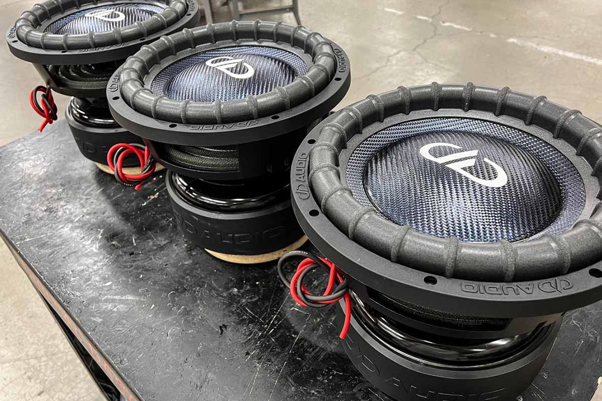 Three USA Made Subwoofers with metallic blue dust caps, cones, and white DDA Logos