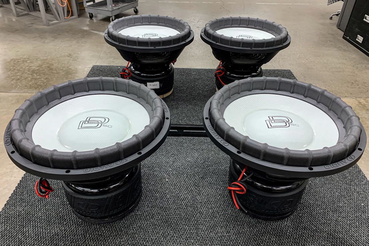 Four USA Made Subwoofers with White Carbon Fiber Cone and Dustcap and Black Classic DD logo and Super Charged decal