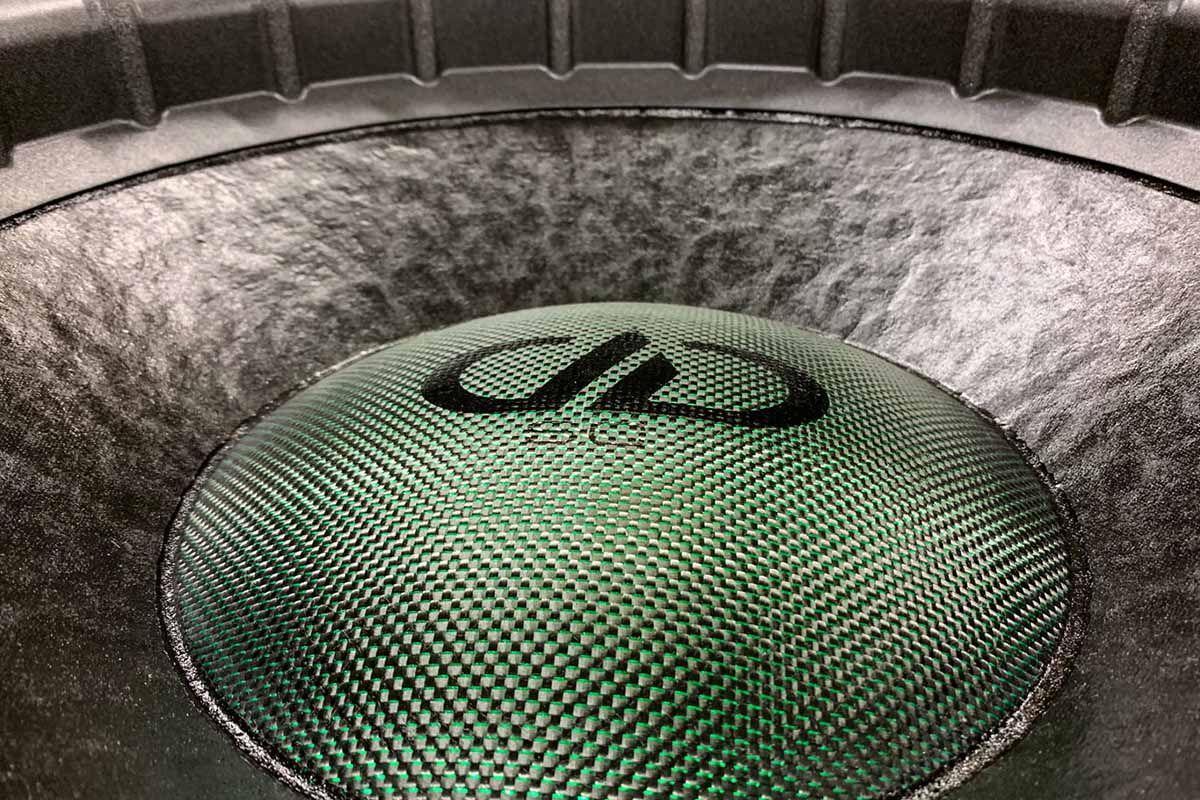 USA Made Subwoofer with black cone, metallic green dust cap, black DDA logo, and black Super Charged decal